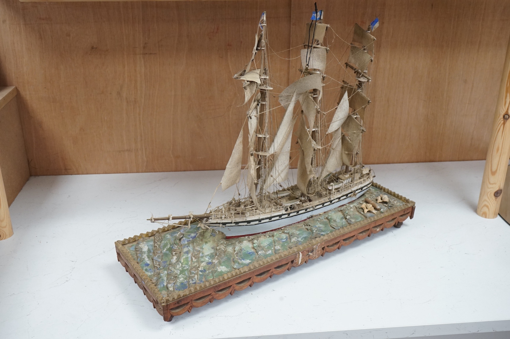 A bone and painted wood model of a three masted ship, 55.5cm wide. Condition - fair to good